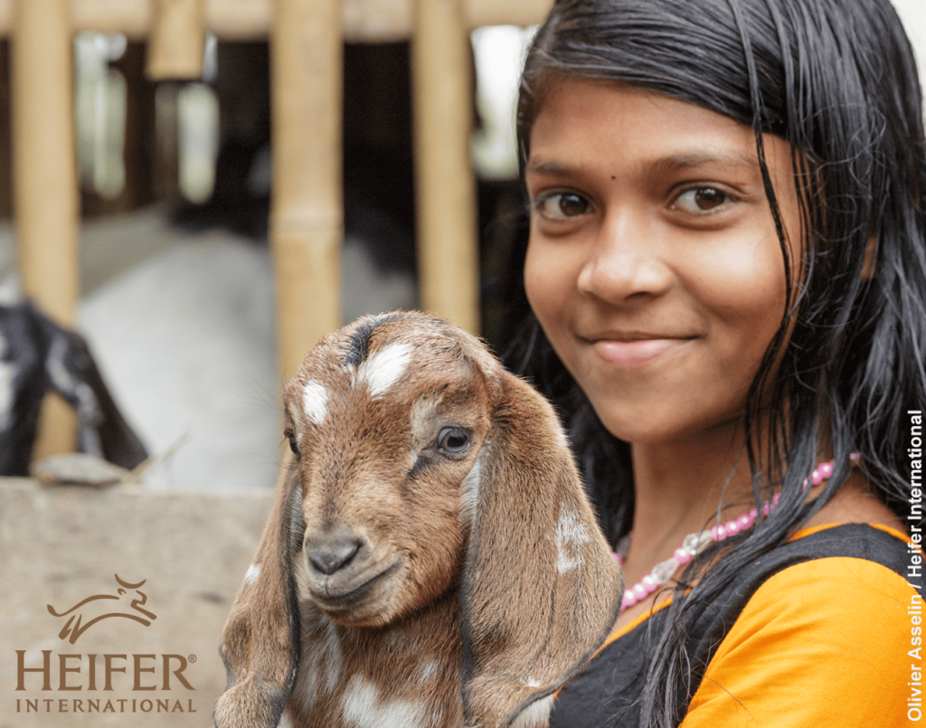 girl holding goat