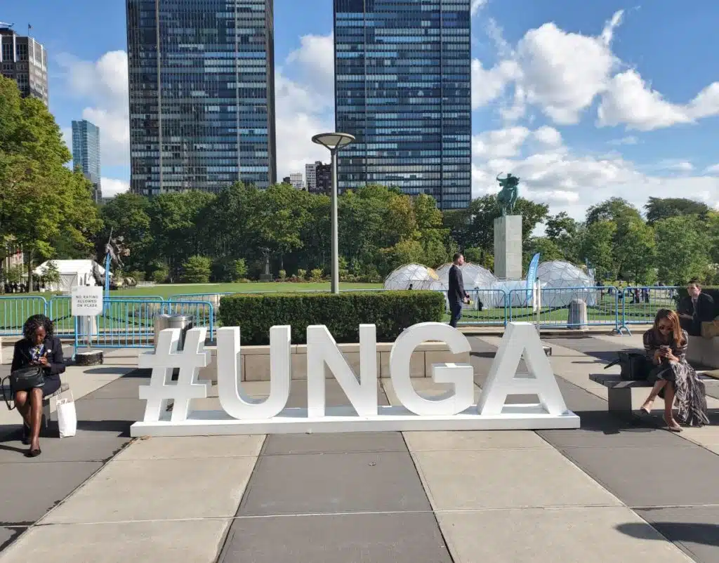 #UNGA sign in front of a city landscape
