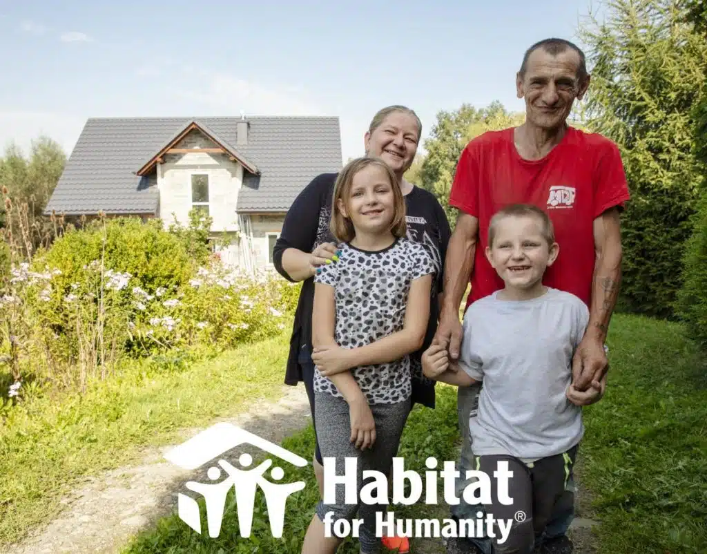 Habitat for Humanity logo over a picture of a family with a house behind them