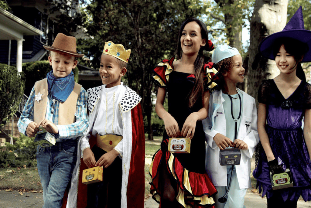 Children trick-or-treating with UNICEF USA boxes.