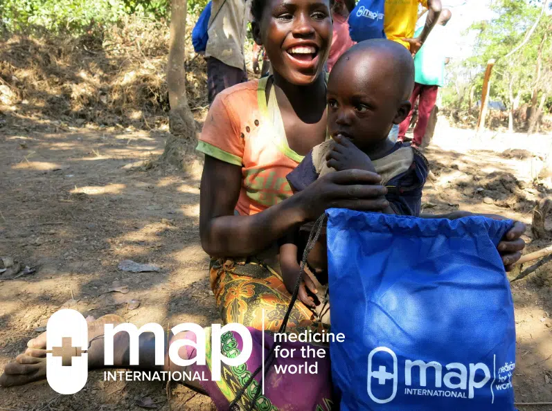 A woman and child with a MAP International Disaster Health Kit.