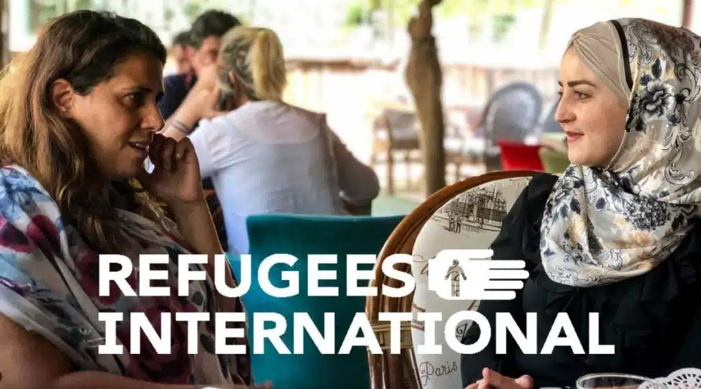 Refugees International logo over picture of women talking