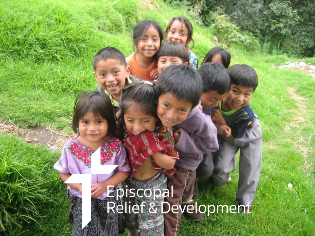 Children in Guatemala smile at the camera.