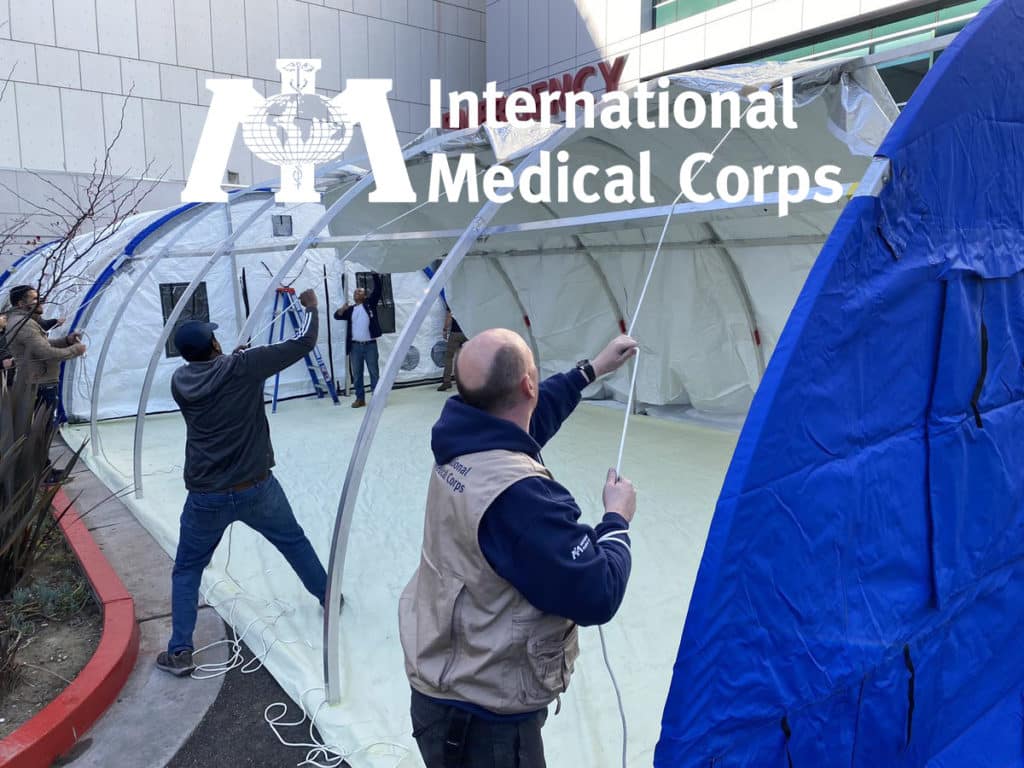 International Medical Corps workers setting up tents in front of the Martin Luther King, Jr. Community Hospital.