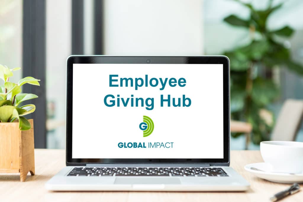 Laptop with white screen reading: Employee Giving Hub Global Impact
