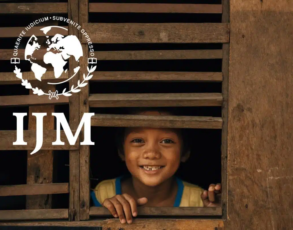IJM logo over photo of a girl looking out a window