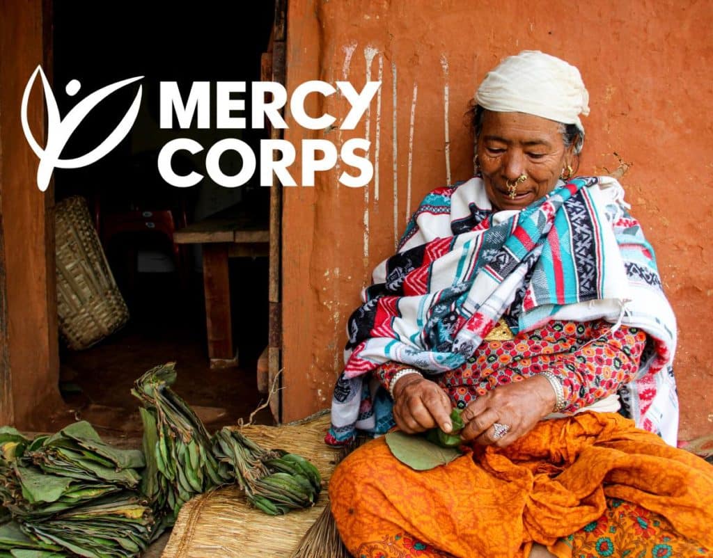 Mercy Corps logo over a photo of an older woman working with her hands