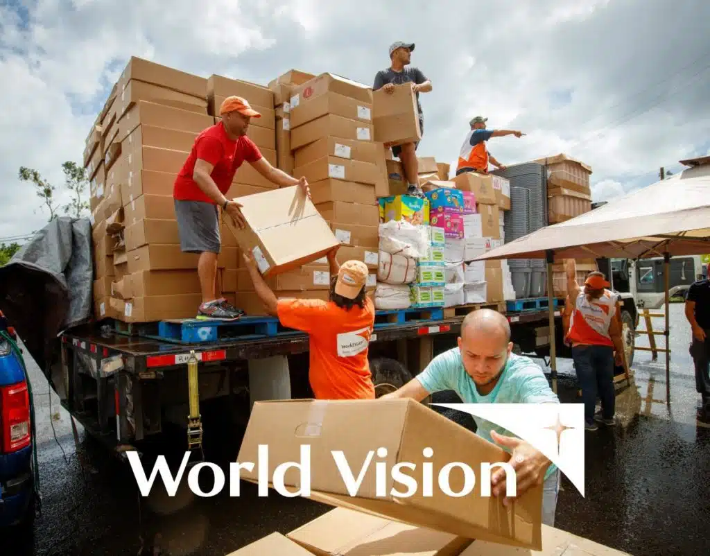 World Vision logo over an image of people moving boxes from a truck