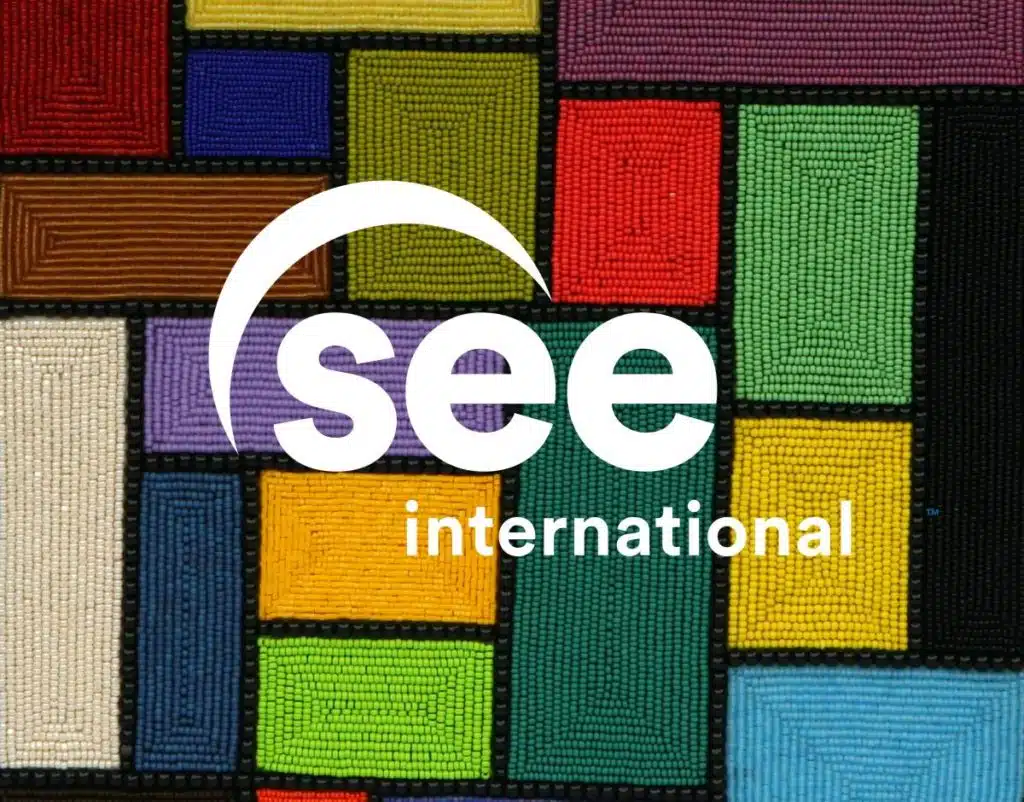 See International logo over a colorful beaded tapestry
