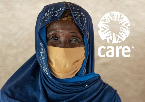 A woman in Niger wearing a headscarf and mask looking forward.
