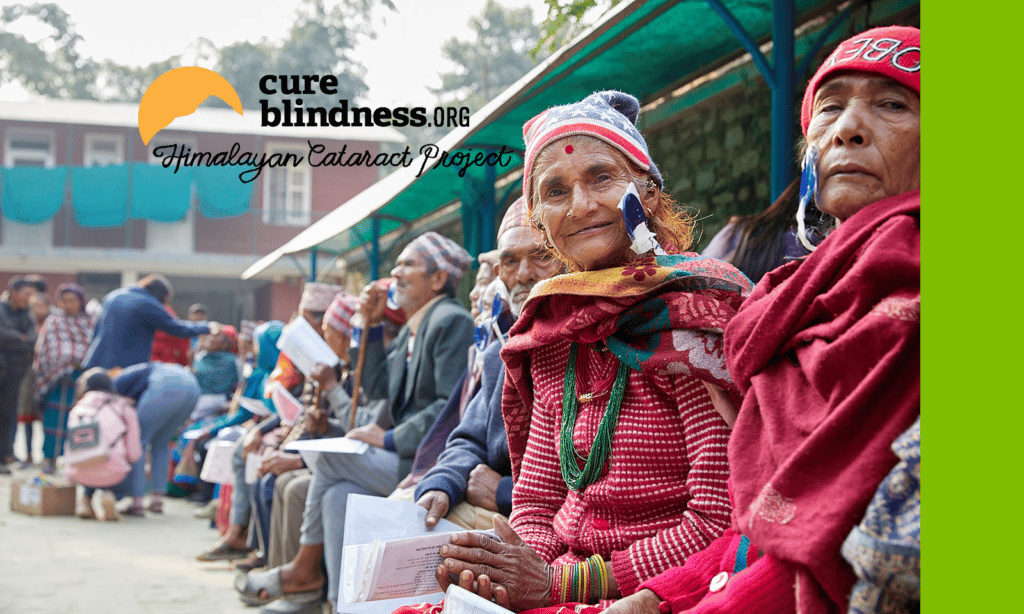 A group of women sitting down outside and looking at the camera. Logo: cureblindness.org Himalayan Cataract Project