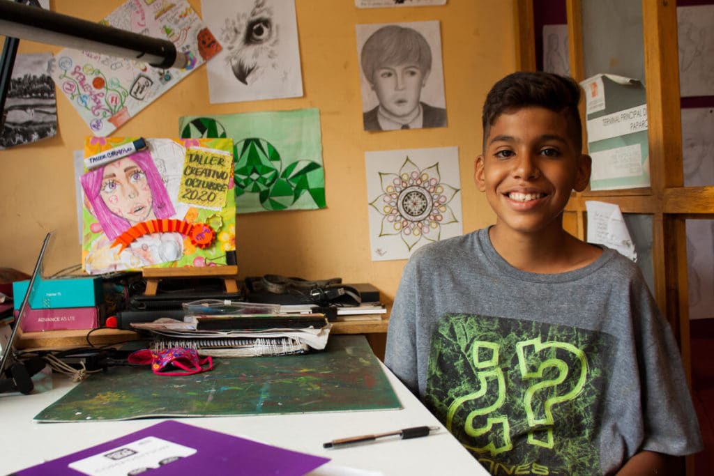 Ibrahim (14) smiles in his teacher's office