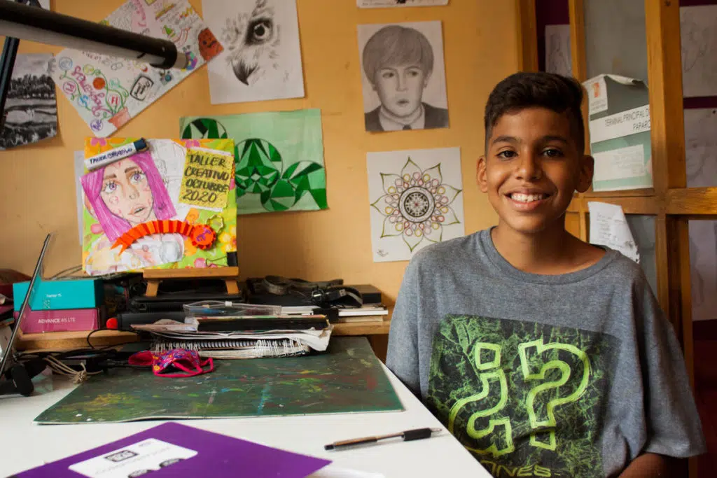 Ibrahim (14) smiles in his teacher's office