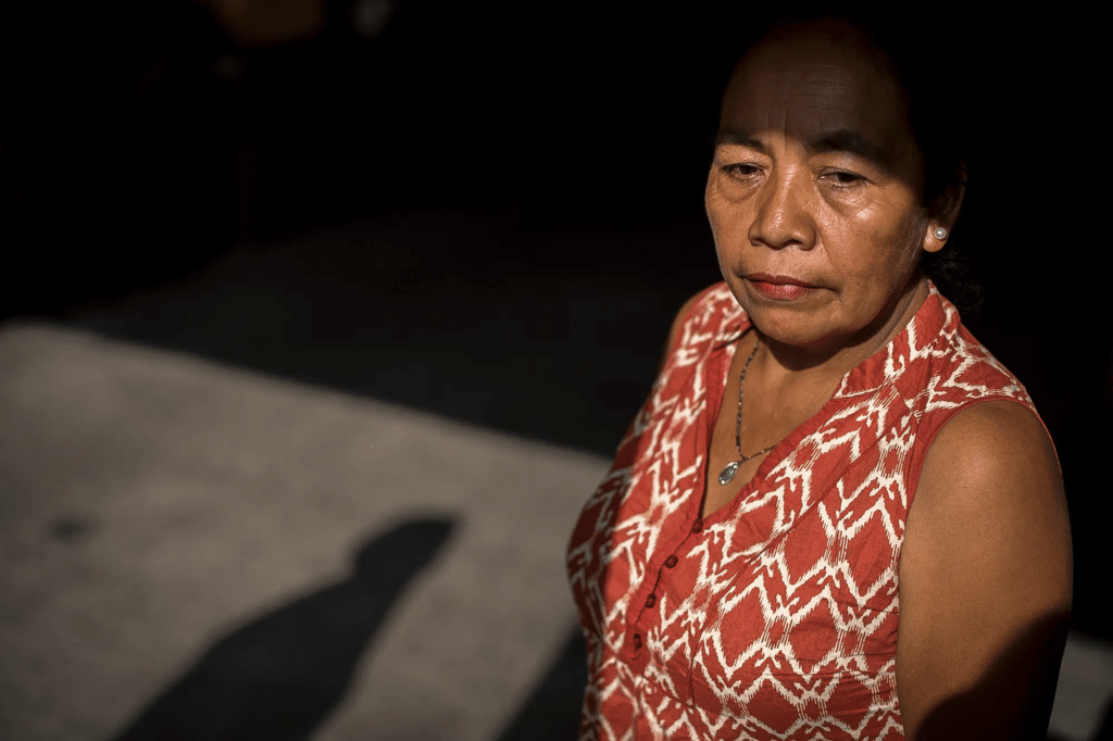 Woman staring off, partially in shadows