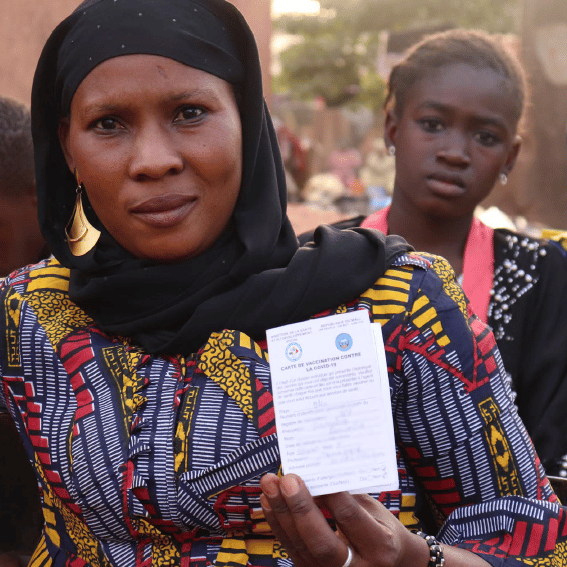 Participant shows off their vaccination  card at a promotional event held by Mali  Health 22/2/2022 in the community of  Sabalibougou in Bamako, Mali.
