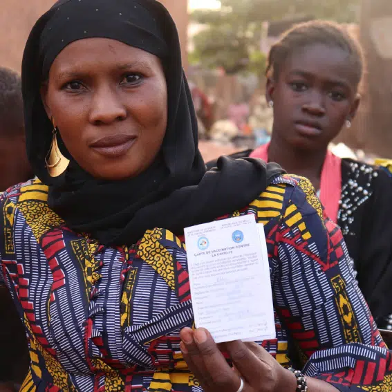 Participant shows off their vaccination  card at a promotional event held by Mali  Health 22/2/2022 in the community of  Sabalibougou in Bamako, Mali.