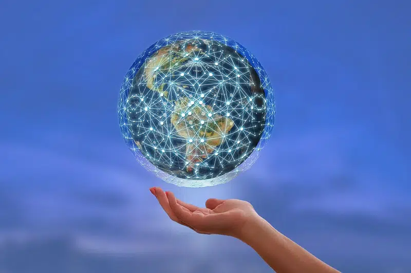 A hand holding a globe