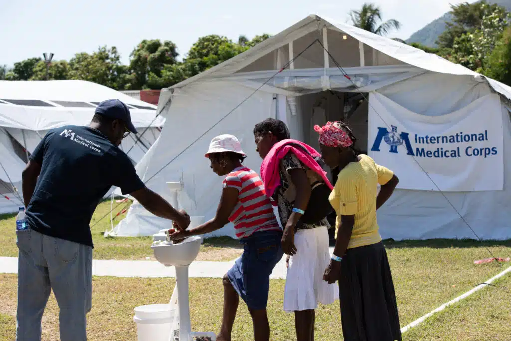 Patients wash their hands at the hospital in Aquin