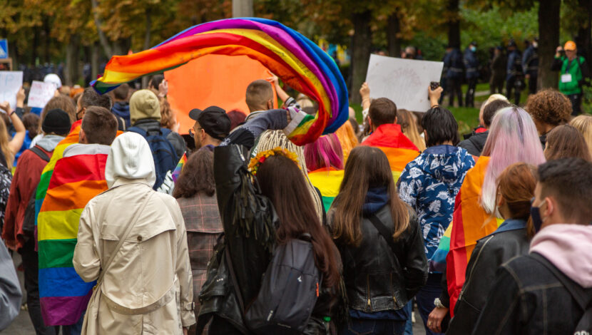 Participants of the Pride Parade in the Kyiv, Ukraine, walk the streets of the city with a rainbow flags and posters. A crowd of young people. Concept LGBTQ.