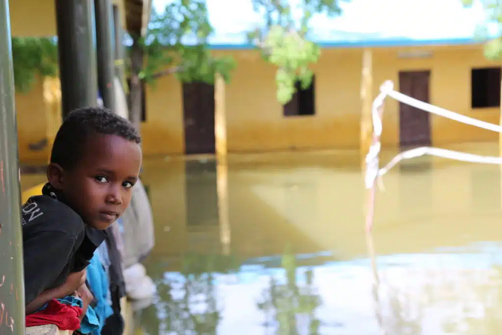 A boy looks out at the flooded street in Somalia