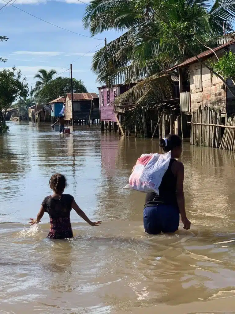 Woman and child in the middle of a flood