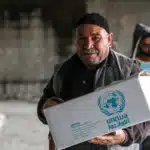 A man holds a food assistance package