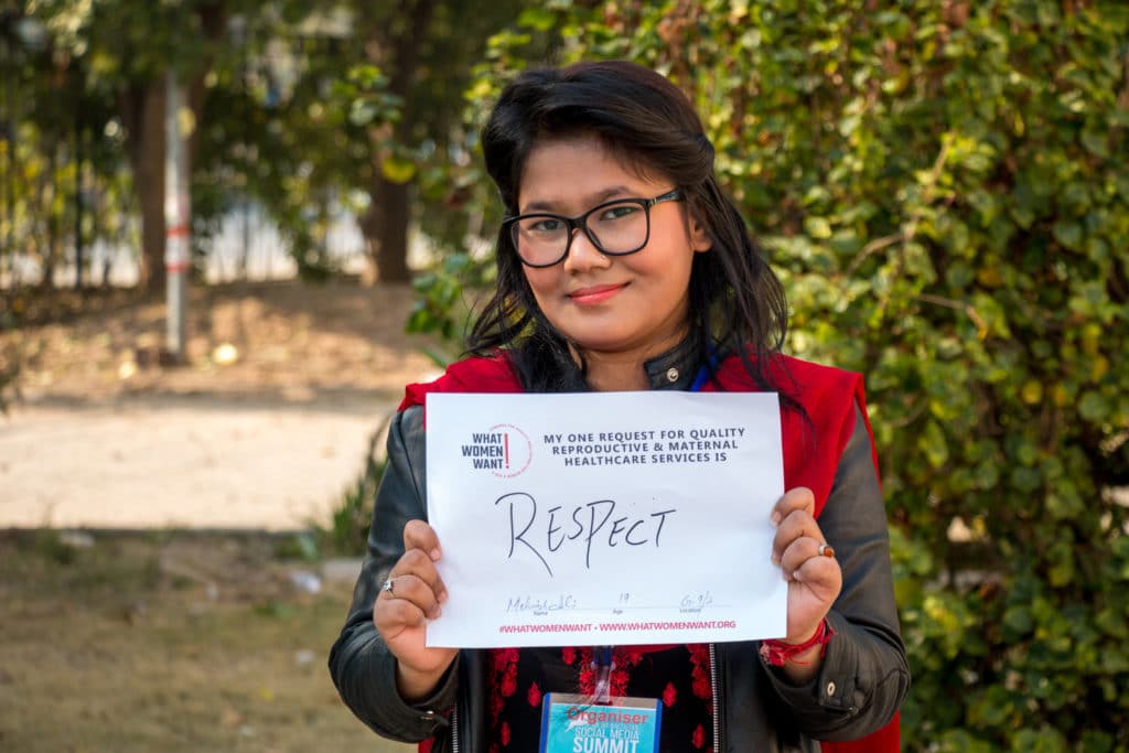 Young woman holding up a sign that says "Respect"