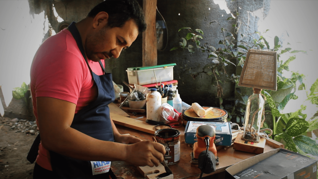 Magdiel Galeano Gómez, a refugee from Nicaragua now living in Costa Rica, works on a product for his business.