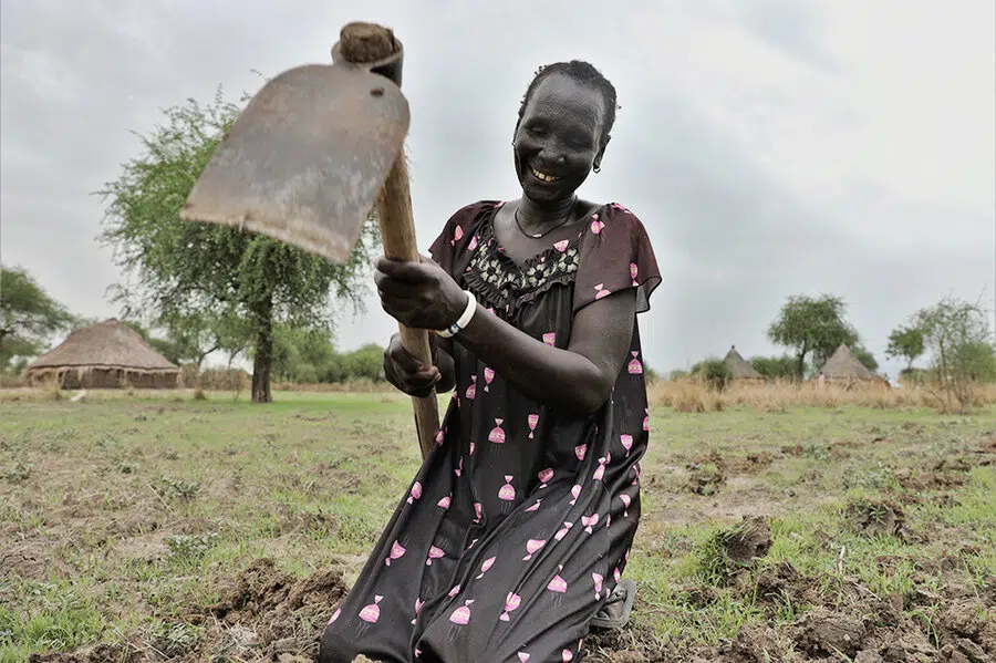 Woman holding a farming tool