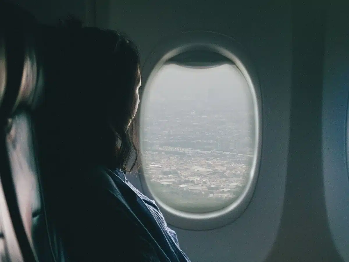 Girl staring out the airplane window