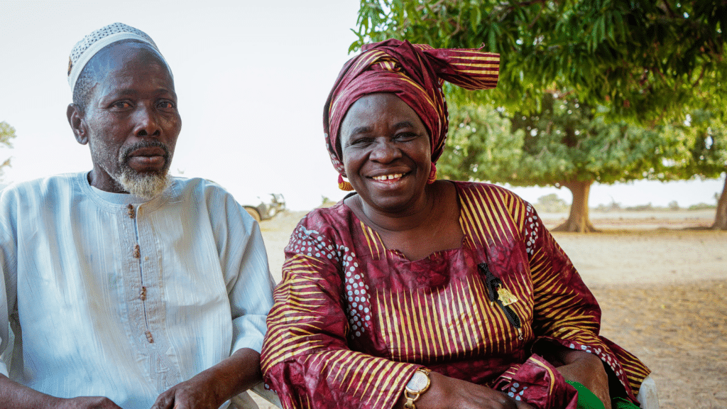 A couple sitting next to each other and smiling