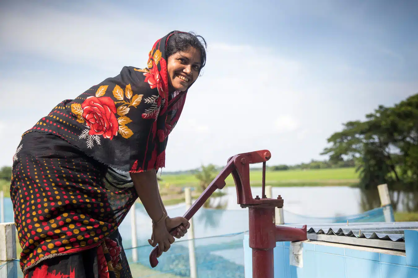 Julia is pumping treated water that is safe for drinking to bring to her family, Bangladesh.