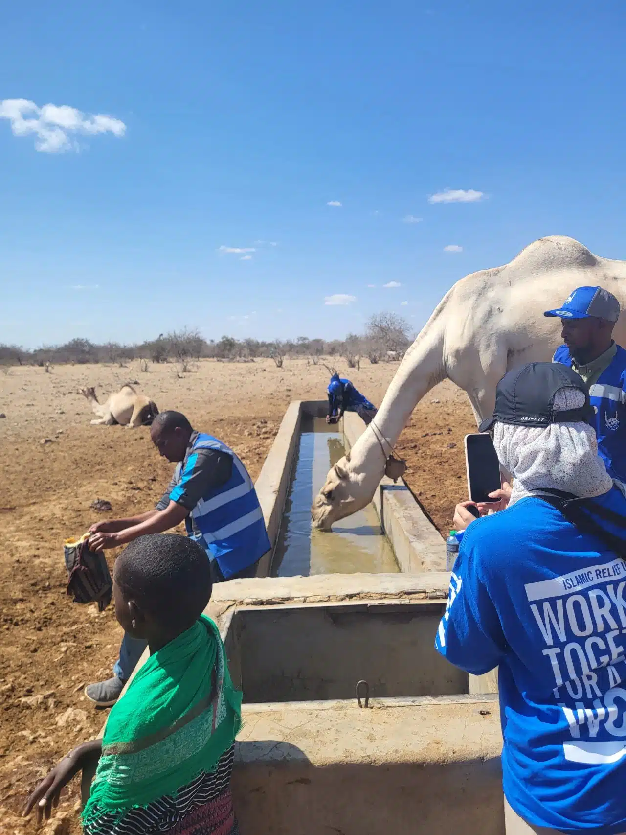 Islamic Relief staff and a camel in Kenya