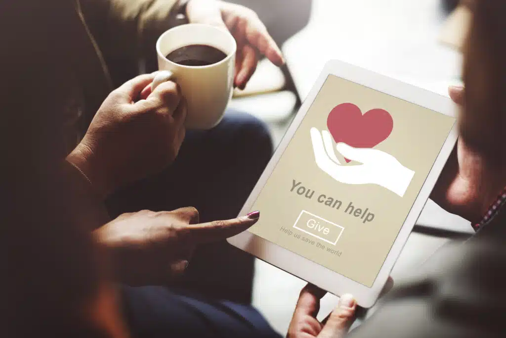 A tablet that says 'You can help' with a GIVE button