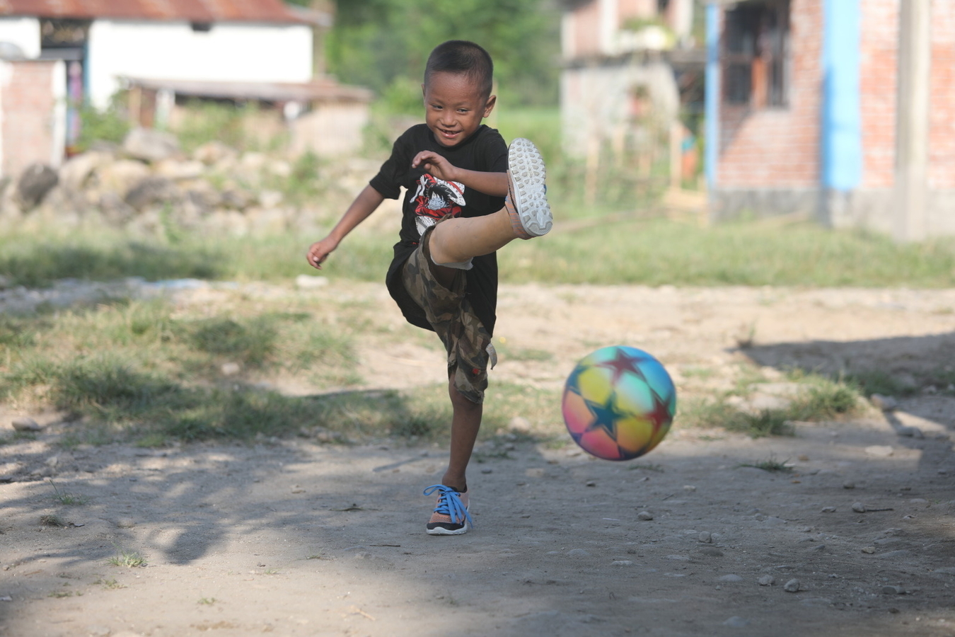 A boy kicks a soccer ball with a new artificial limb