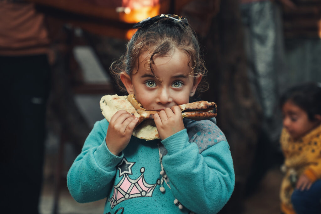 Hala is eating freshly baked manakish