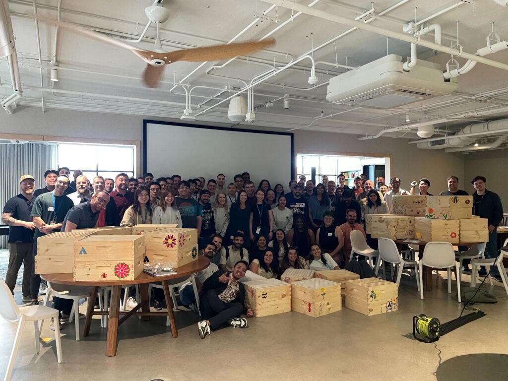 A corporate group gathered after finishing their bee habitats together.