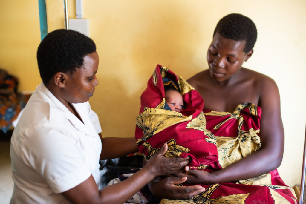 A mother and medical professional holding a baby