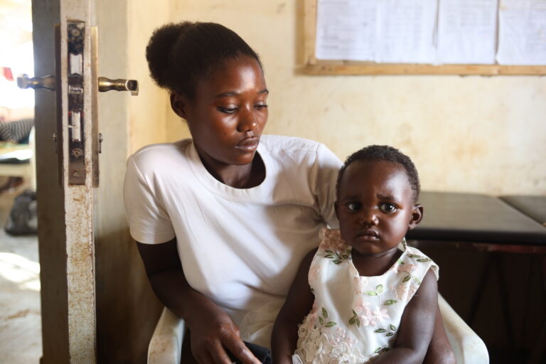 A mother looking at her child on her lap